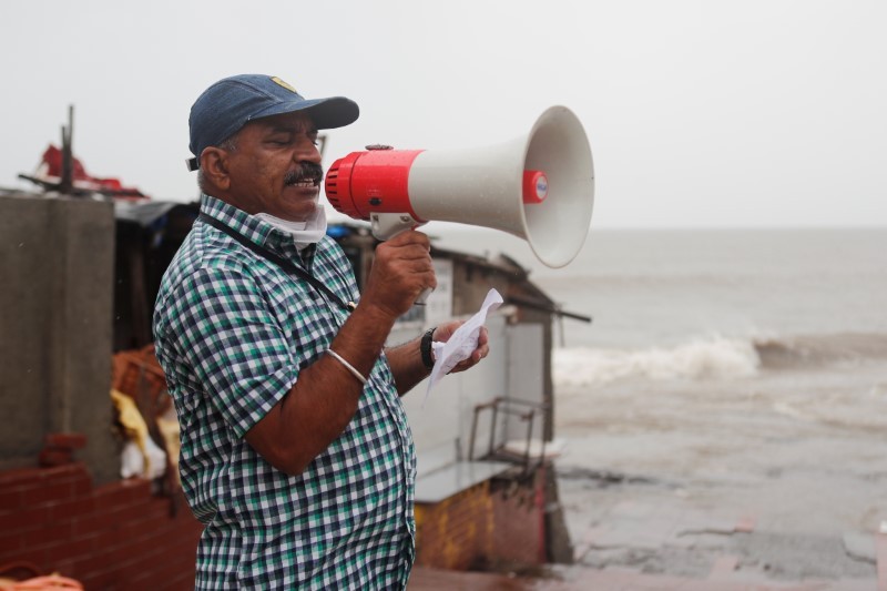 A Brihanmumbai Municipal Corporation (BMC) official makes an announcement to stay indoors over a loudspeaker before cyclone Nisarga makes its landfall, in Mumbai, India June 3, 2020. REUTERS/Francis Mascarenhas